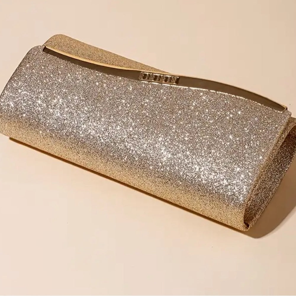 Gold glittery clutch bag on a beige background