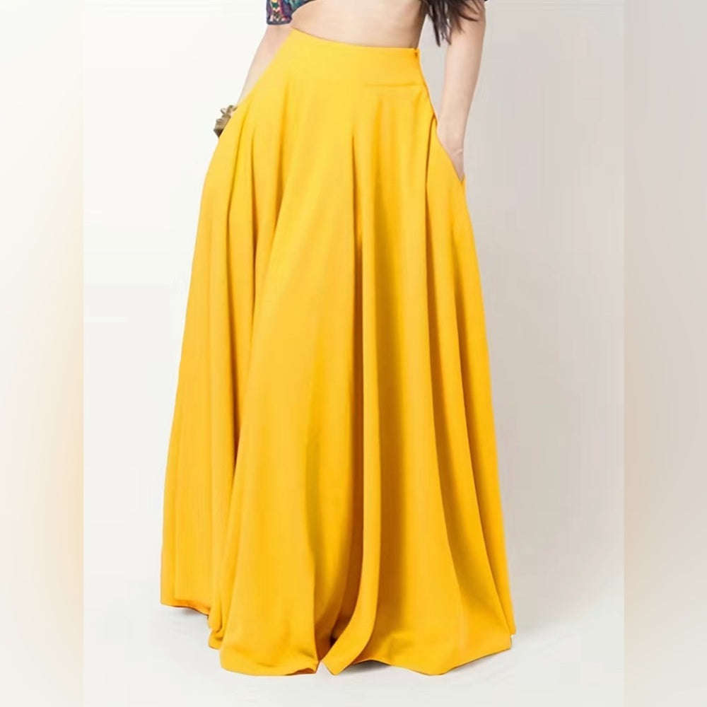 Yellow maxi skirt worn by a person on a white background
