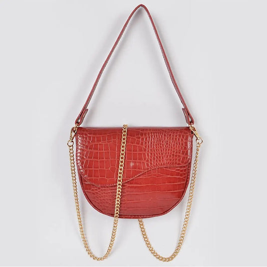 Red handbag with gold chain strap on a light gray background