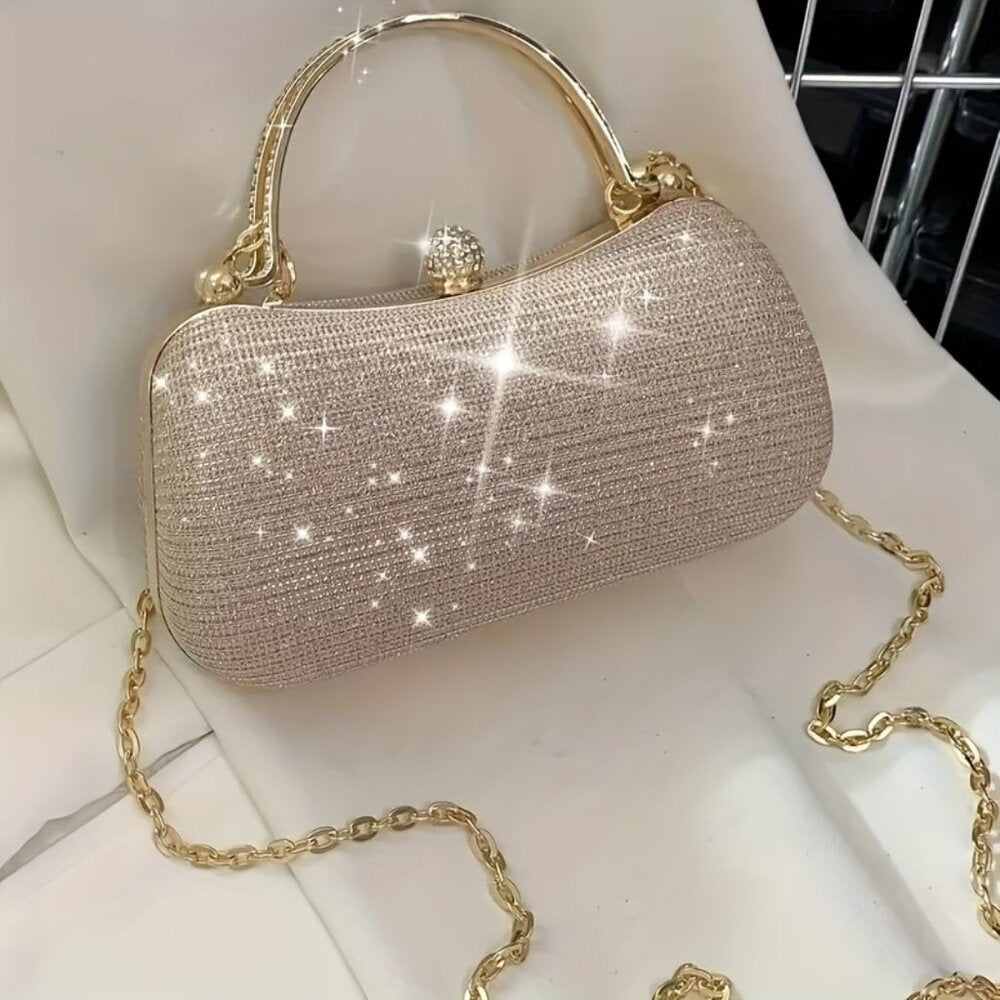 Sparkly handbag with gold chain on a white surface