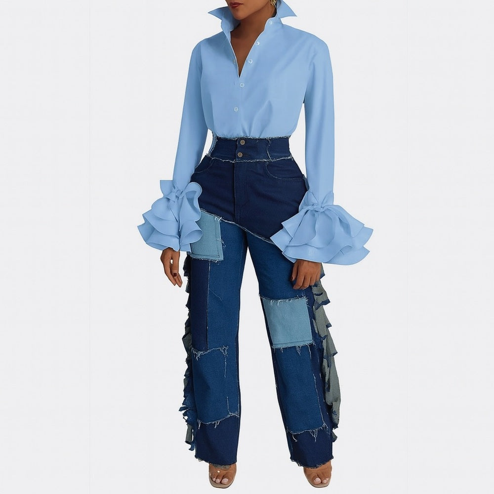 Woman wearing a blue blouse with ruffled sleeves and patchwork jeans on a white background