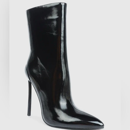 Black high-heeled boots on a light gray background