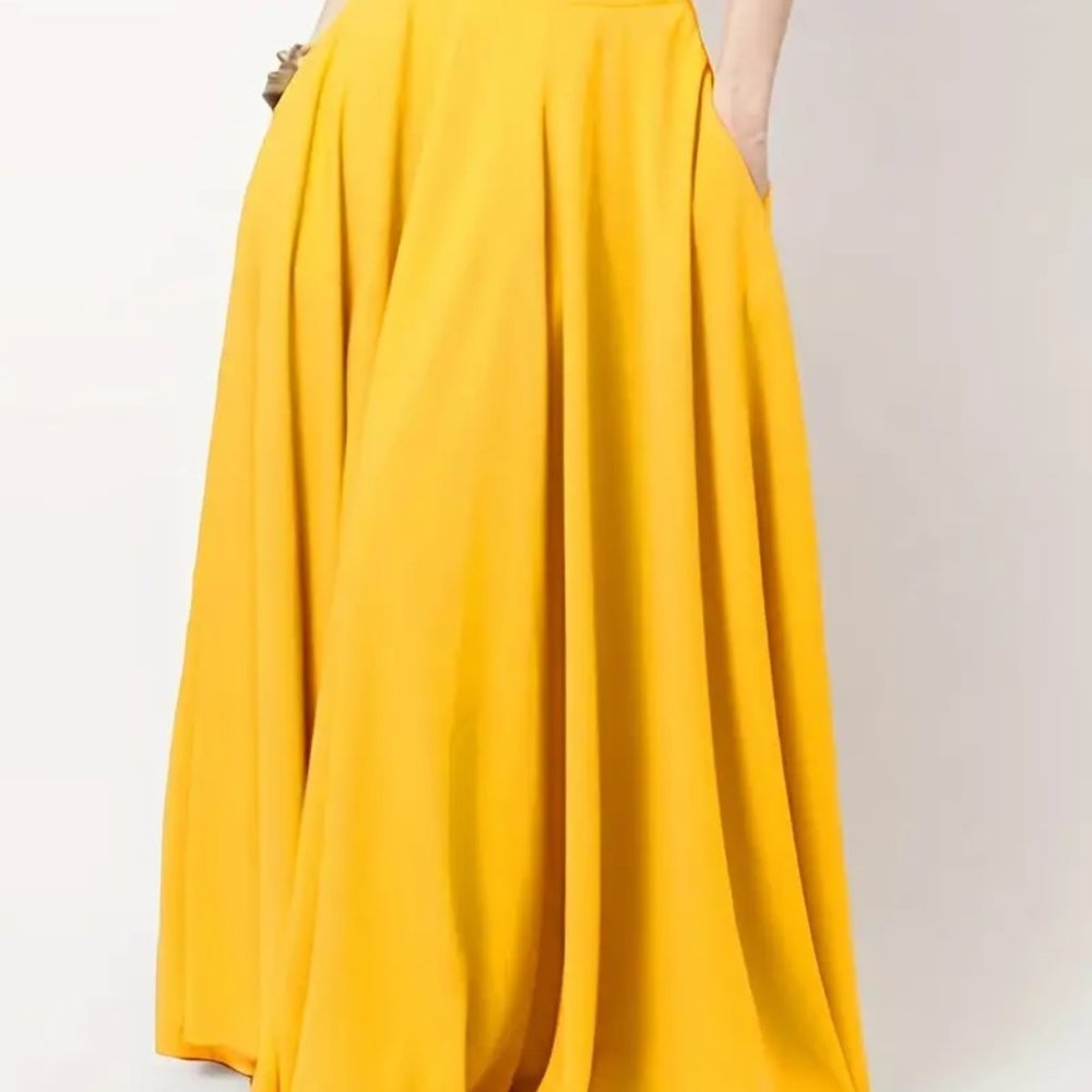 Yellow dress with long sleeves on a light gray background