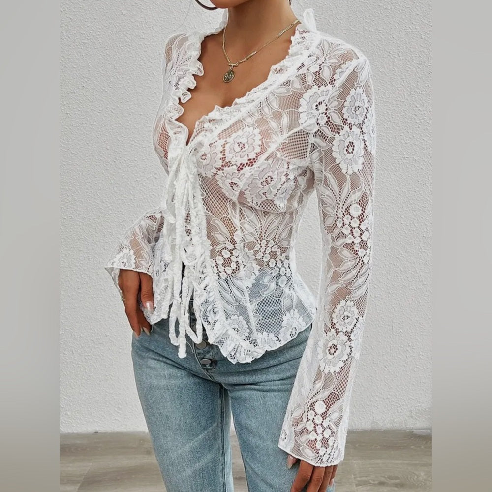 White lace top worn by a person against a plain background