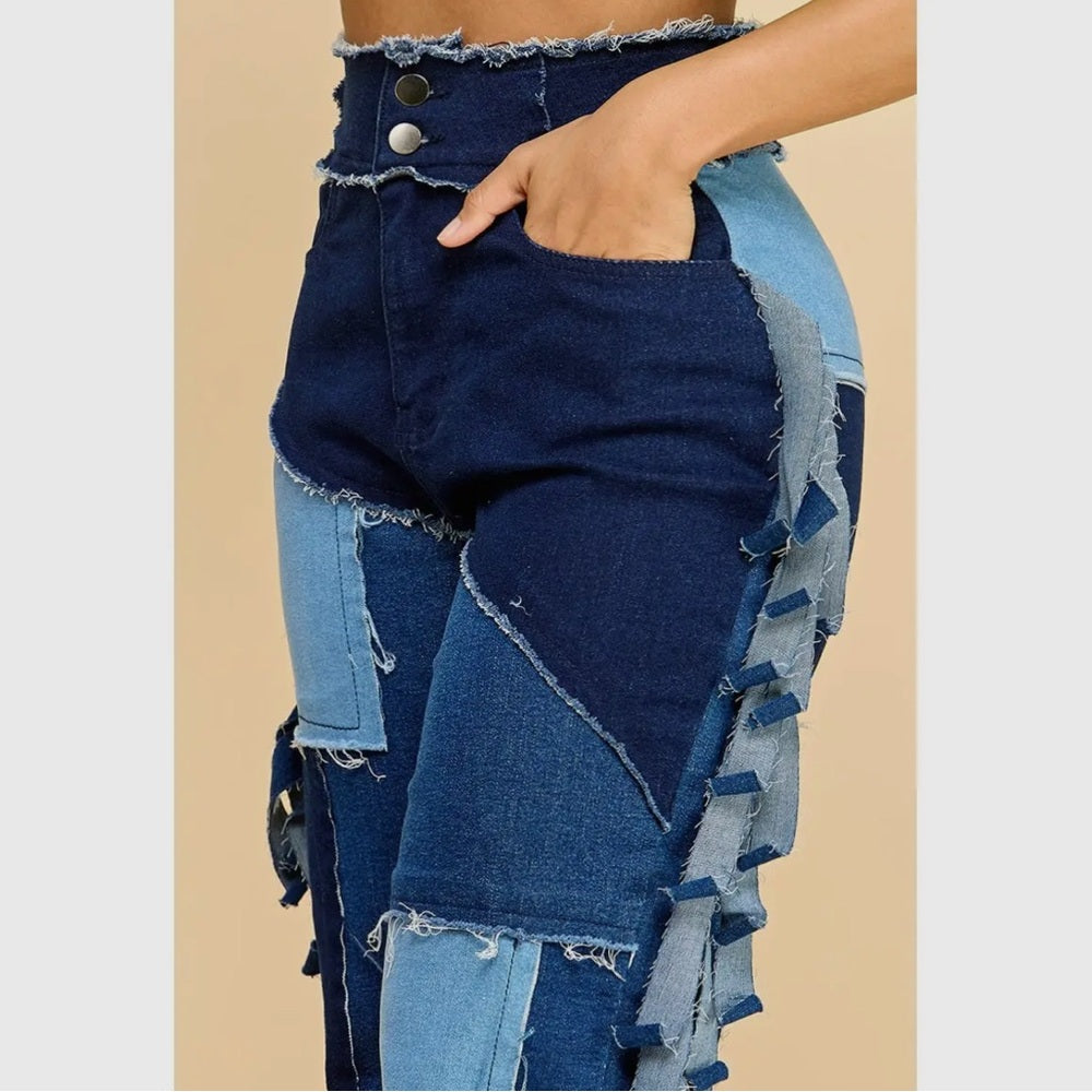 Blue denim jeans with patchwork design on a beige background