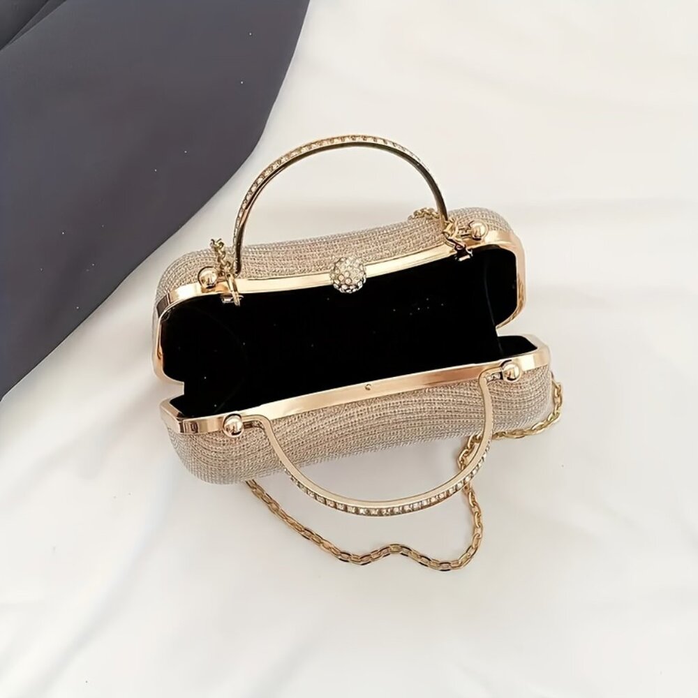 Gold evening bag with chain strap on a white background